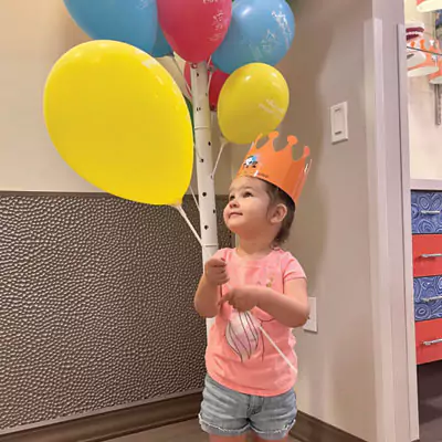 Child Holding Ballons